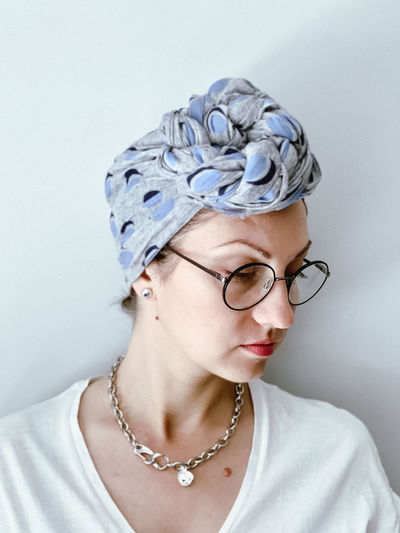 Candid millennial woman wears african style headscarf and glasses.  muslim wears hijab fashionably