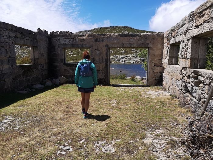 Full length rear view of woman standing against sky