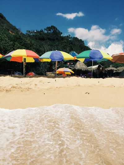 Scenic view of beach against blue sky
