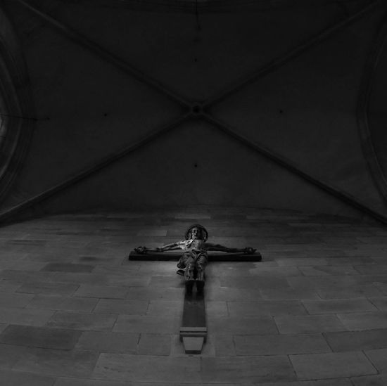 High angle view of cross statue on floor