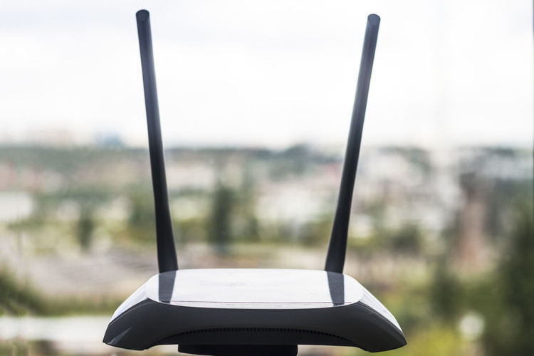 Close-up of wireless router by window