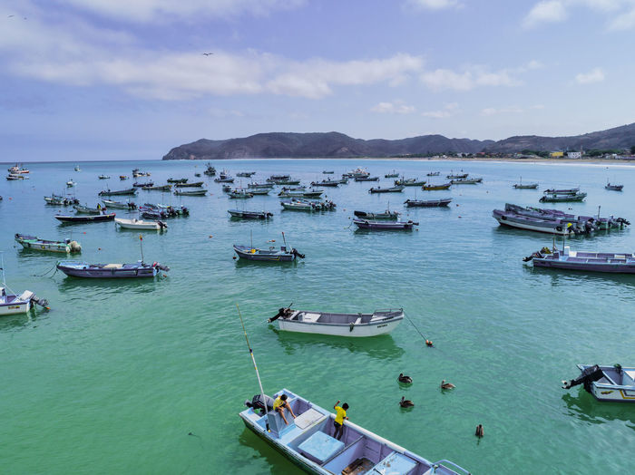 High angle view of boats moored in sea against sky