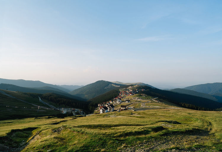 Scenic view of town and mountains in the morning sun