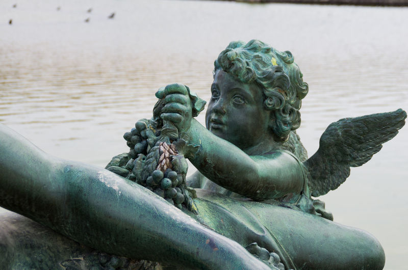 Angel statue by lake