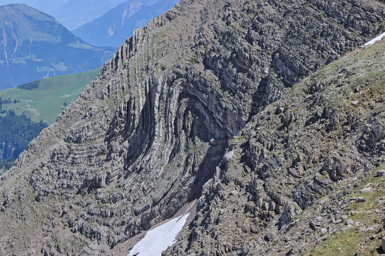 Rock folded into syncline in alpine swiss mountains. s-fold found at steep mountain side.