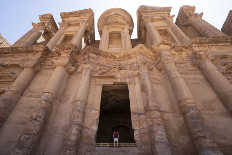 A man contemplate the monastery monument carved in mountain, petra, jordan