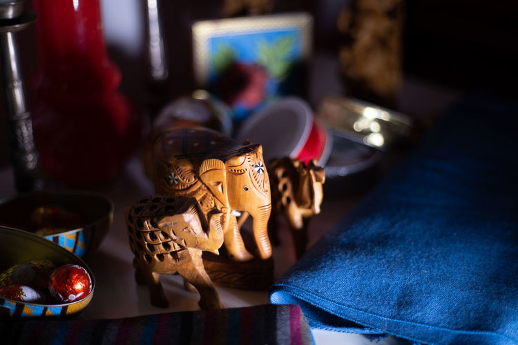 Close-up of elephant figurines on table at home