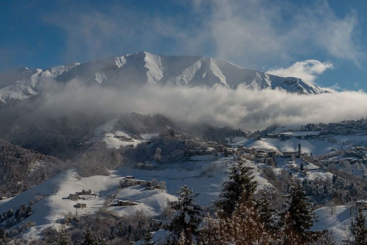 Scenic view of snowcapped mountains against sky