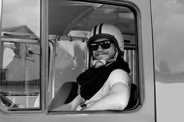 Portrait of smiling man sitting in fire engine