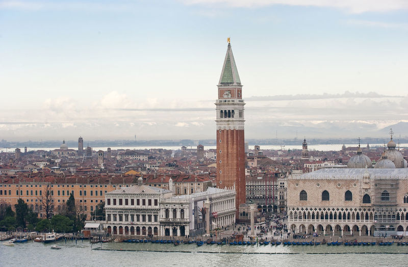 St mark cathedral and campanile by grand canal against sky