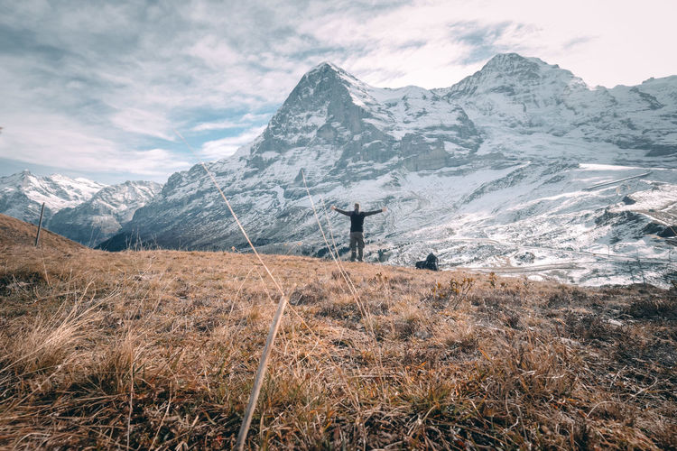 Man standing against snowcapped mountains