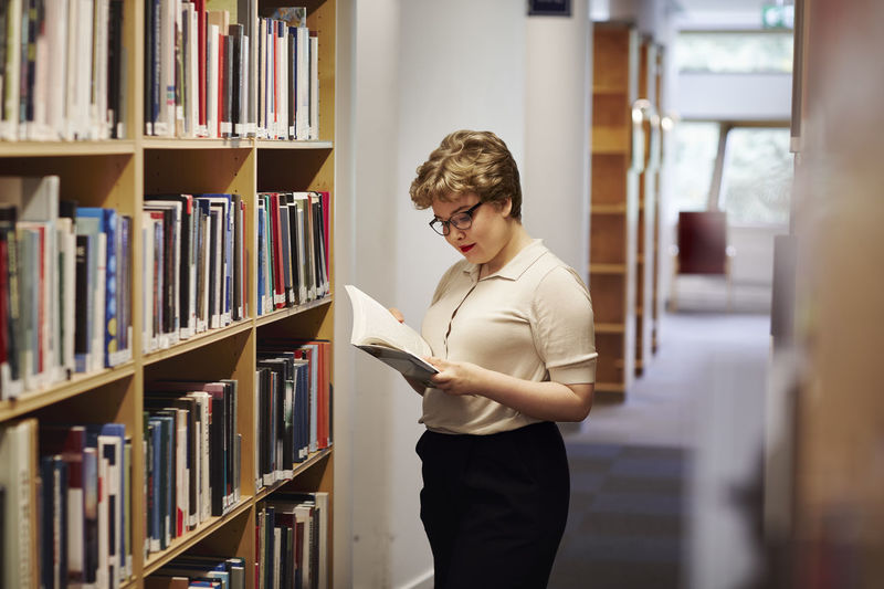 Side view of woman looking at library