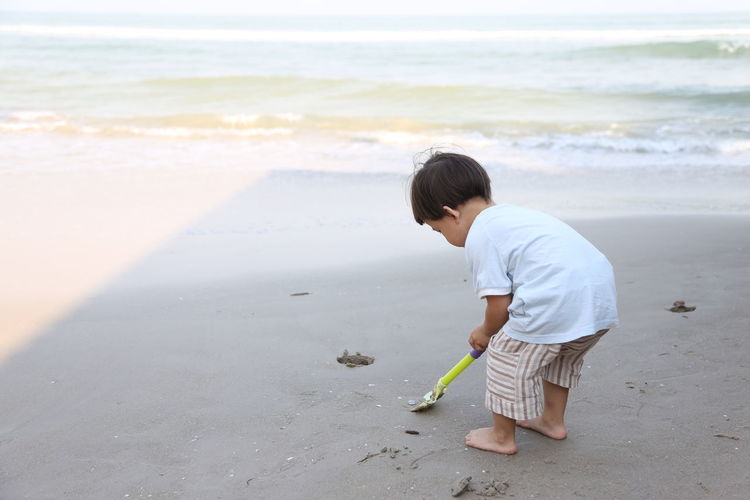 Boy standing on beach