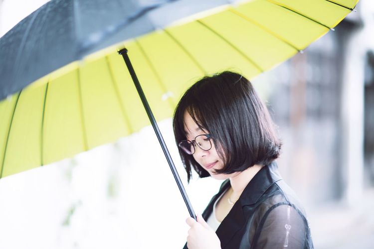 Portrait of woman holding umbrella