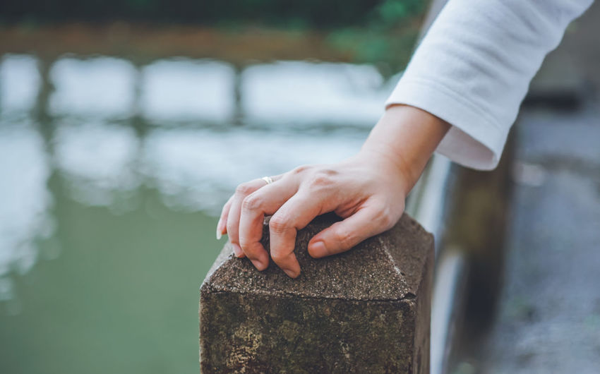 Cropped hand of person on railing