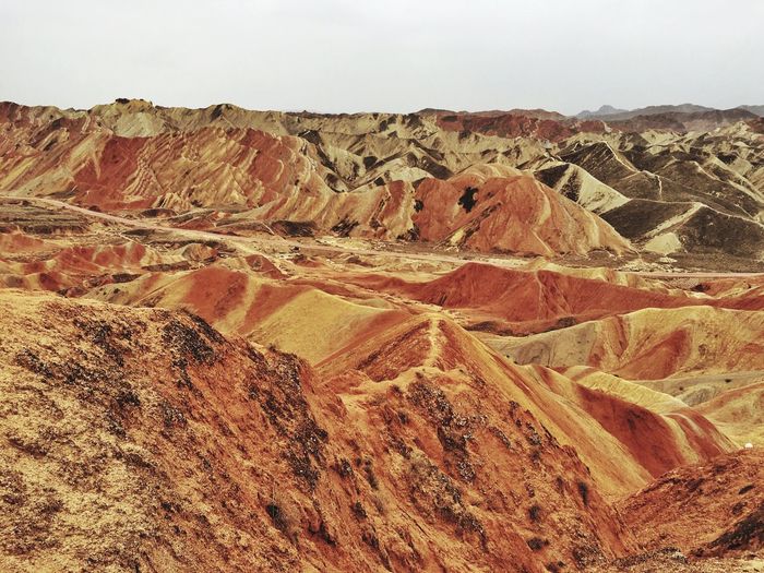 Scenic view of zhangye danxia national geological park against cloudy sky