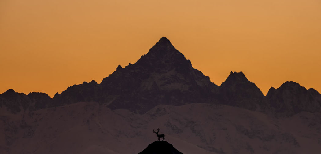Scenic view of mountains against sky during sunset