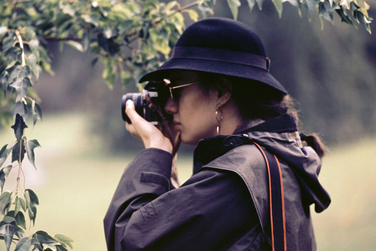 Close-up of woman photographing with camera