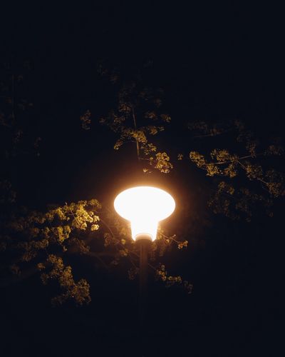 Low angle view of illuminated lights at night