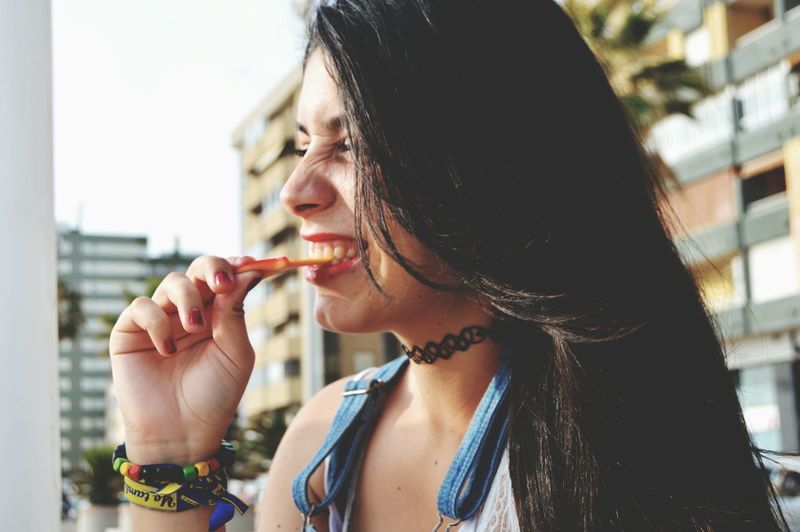 Close-up of young woman snacking