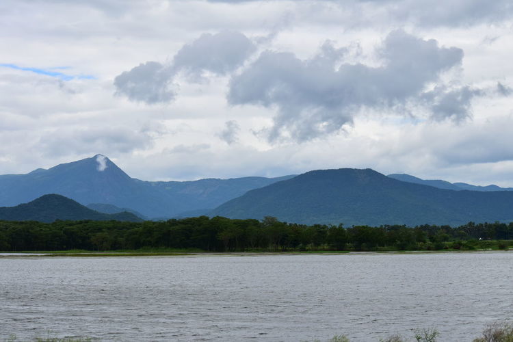 Scenic view of lake and mountains against sky