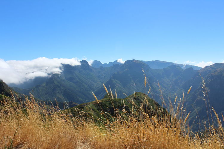 Scenic view of mountains against clear blue sky