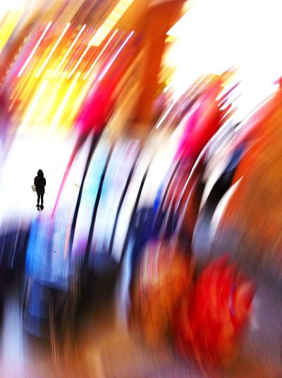 Blurred motion of people walking on road