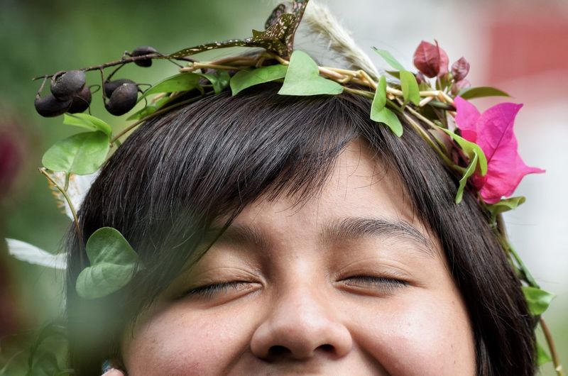 Close-up portrait of girl with flowers