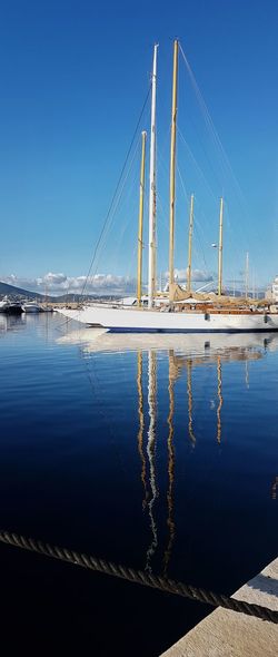 Scenic view of sailboat moored in saint-saint-tropez harbour against clear blue sky
