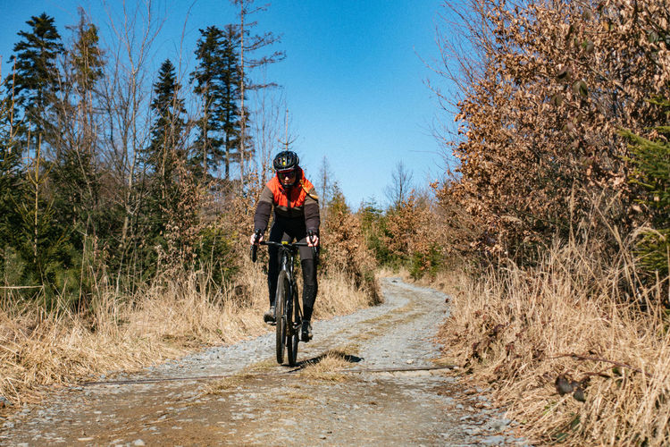 Woman riding bicycle on dirt