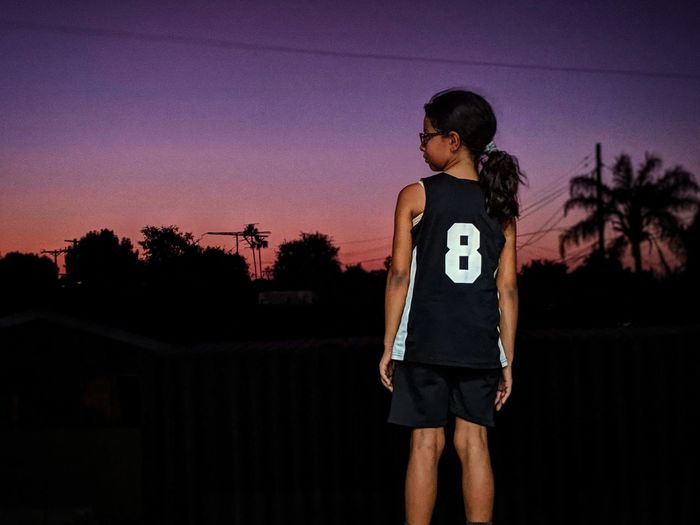 Full length of woman standing against sky during sunset