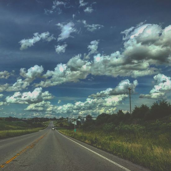 Road by landscape against sky
