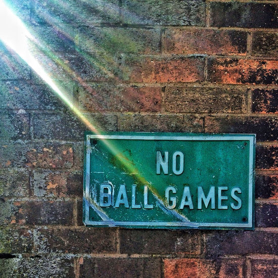 Close-up of text on brick wall