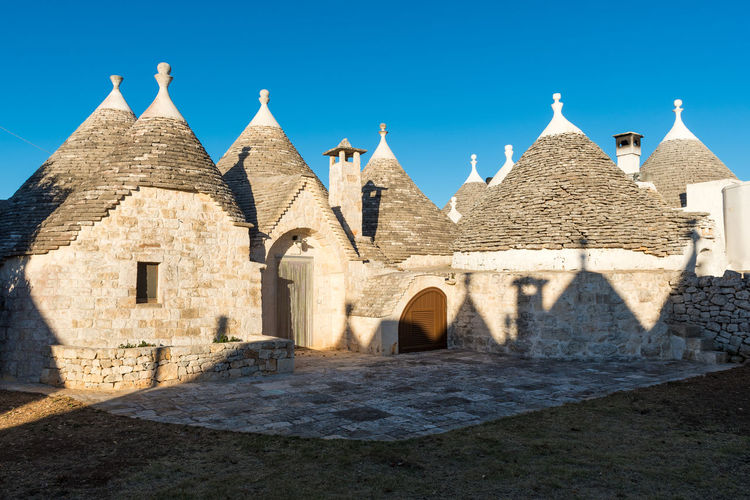 Group of beautiful trulli, traditional apulian dry stone hut old houses with a conical roof 
