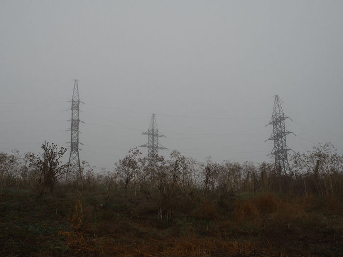 Electricity pylon on landscape against sky