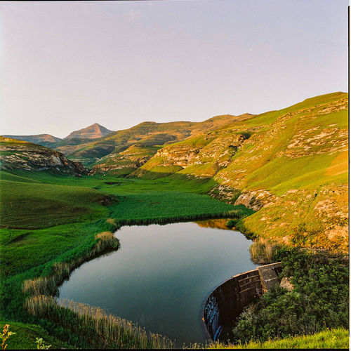Scenic view of lake and mountains against clear sky