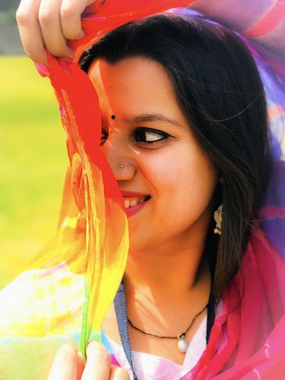 Close-up of young woman holding dupatta