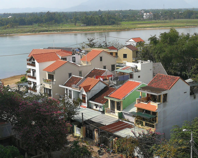 High angle view of townscape by river against buildings