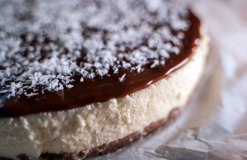 Close up of a chocolate cake decorated with flaked coconut, homemade pie dessert, selective focus