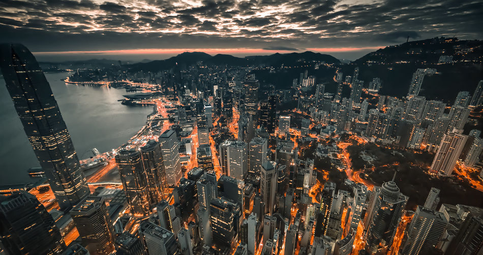 High angle view of illuminated buildings against sky at night