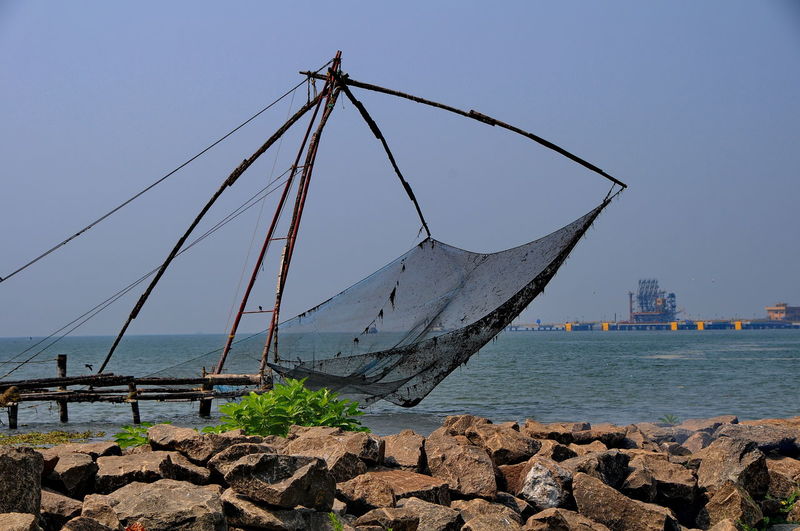 View of fishing net on beach against sky