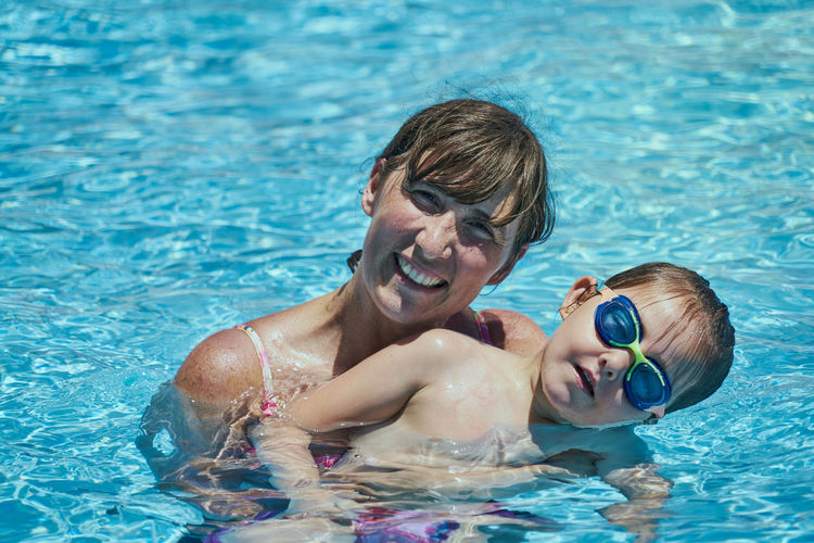 A happy mother and her daughter, an adorable smiling boy having fun to