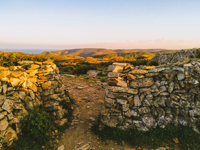 Scenic view of landscape against clear sky during sunset