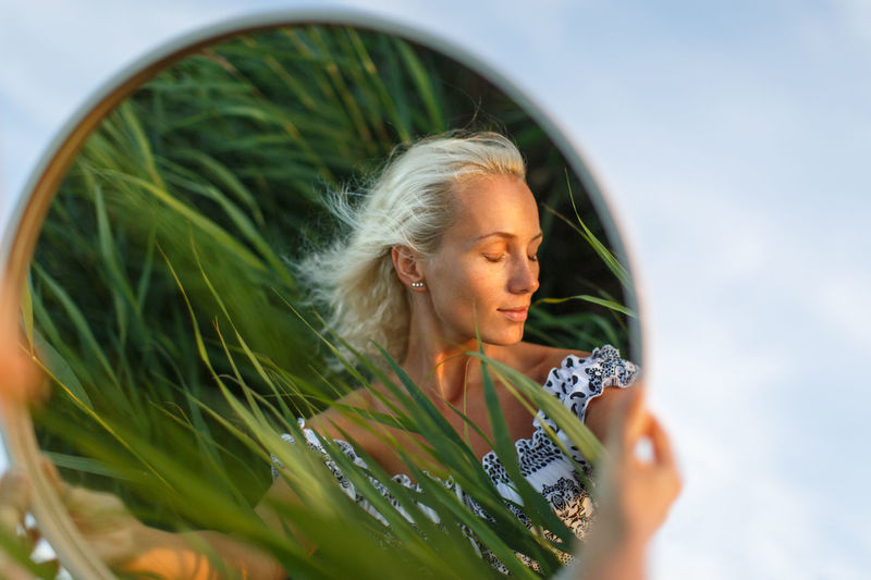 Close-up of woman reflecting on mirror