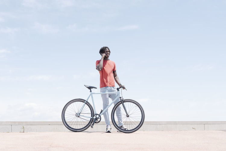 Man riding bicycle on embankment