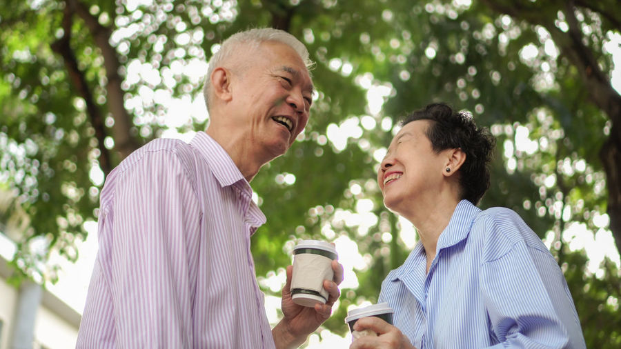 Man and woman drinking glass outdoors