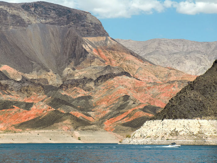 Multicoloured red and black rock view of mountain by lake mead in nevada 