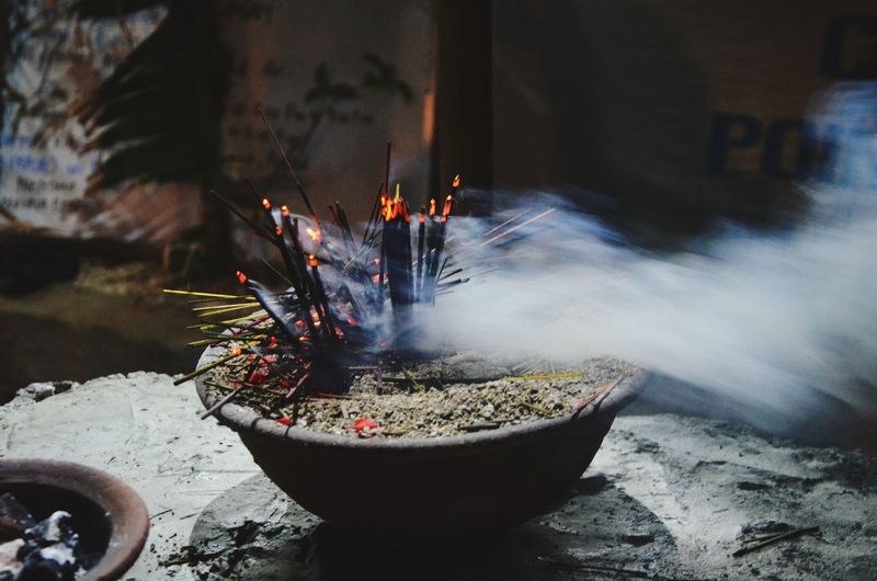 Close-up of burning incense sticks in temple