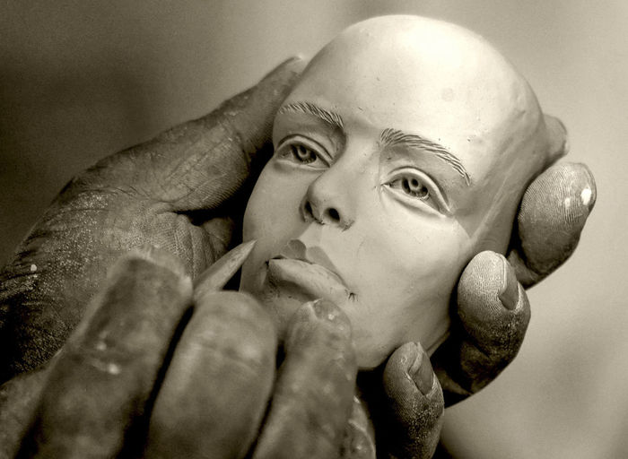Cropped image of artist making human sculpture