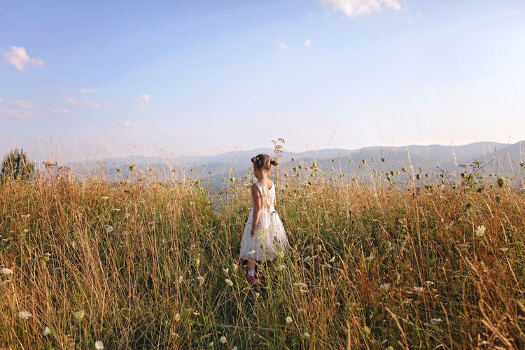 Woman on field against sky